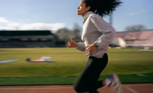 Person running fast on outdoor track
