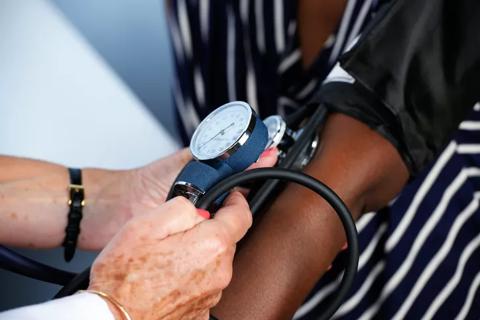 blood pressure cuff on a woman's arm