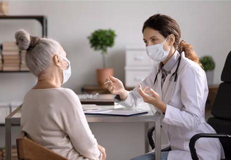 Woman and physician discuss medical result in office setting