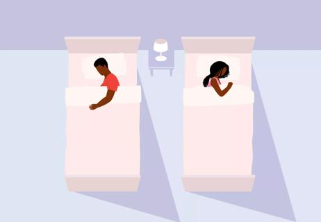couple sleeping in separate beds