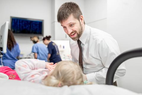 Dr. Weaver smiling with a pediatric patient