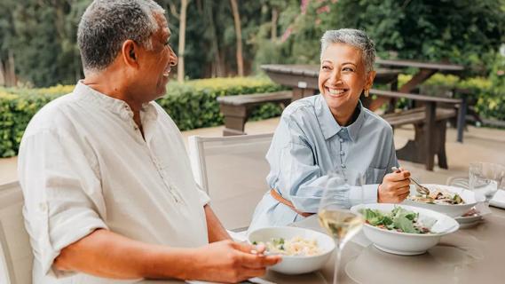 Older couple eating lunch on outdoor patio