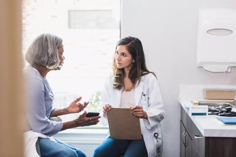 Healthcare provider and patient talking in exam room