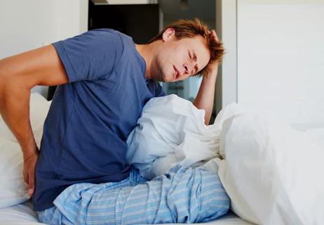 Man in morning with chronic back pain