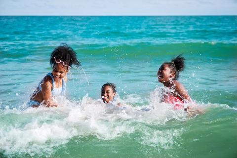 Kids playing in ocean/sea waves