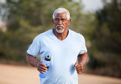 elderly man exercising with water in hand
