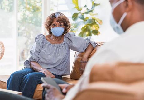 elderly woman masking at home with son