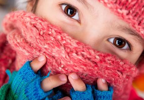 child wearing scarf over face in winter