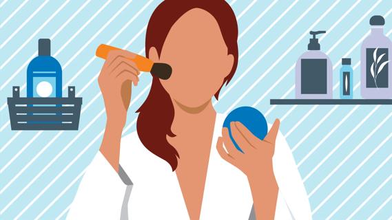 Person in bathroom, applying cosmetic to face with makeup brush