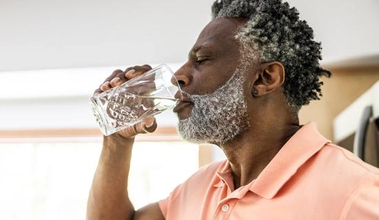 Older person drinking a glass of water