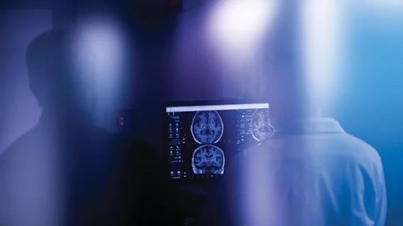 Artistic image of physician reading brain scans