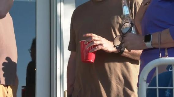Person drinking outdoors