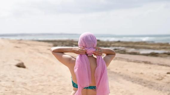 Woman wearing pink scarf