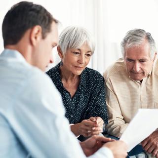 couple looking at paperwork with a financial adviser