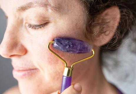 woman using face roller