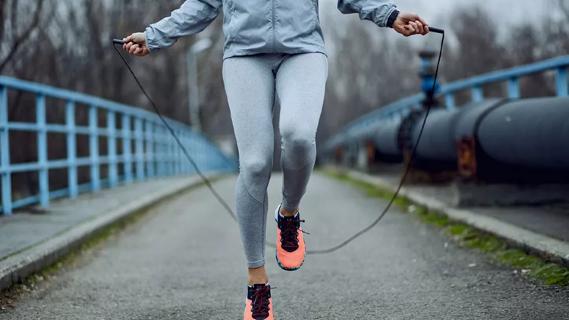 Person jumping rope on a bridge