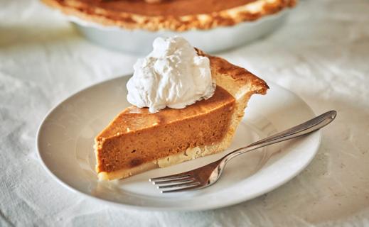 slice of pumpkin pie on a plate with a fork