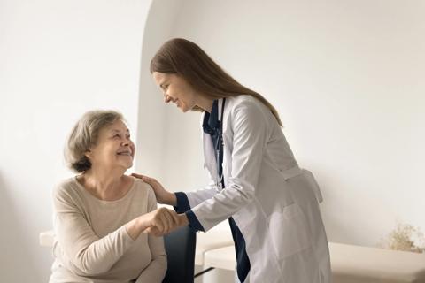 Healthcare provider visiting with older person