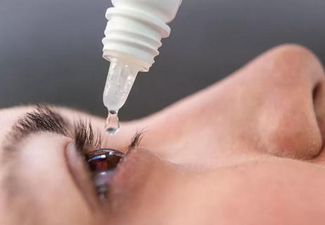 safe eye drops being put into eye