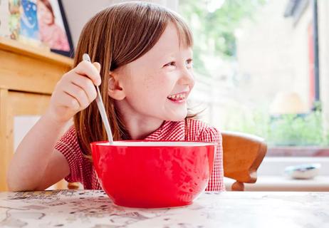 Little girl eating breakfast