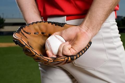 Baseball pitcher with glove and ball