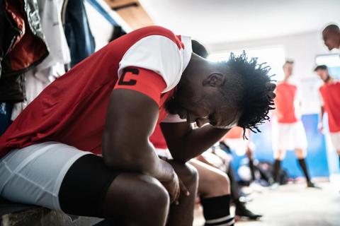 Athlete clutching his head
