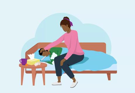 parent caring for child's fever in bed