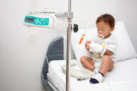 Child with a feeding tube in a hospital bed