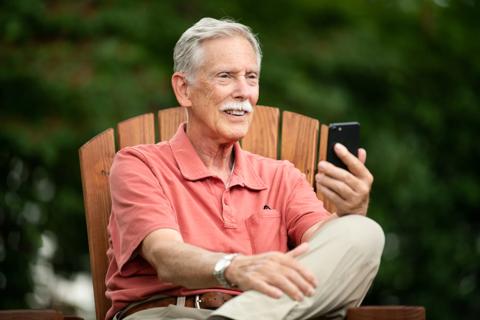 Older man looking at phone