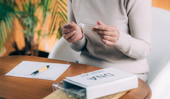 Person unboxing an at-home DNA kit