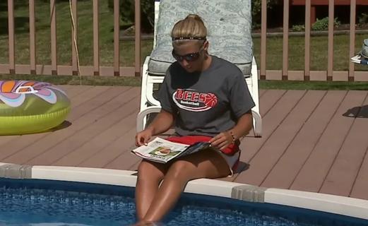Person sitting poolside