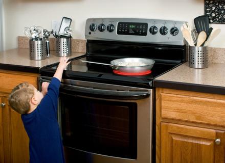 Child reaching toward a hot stove