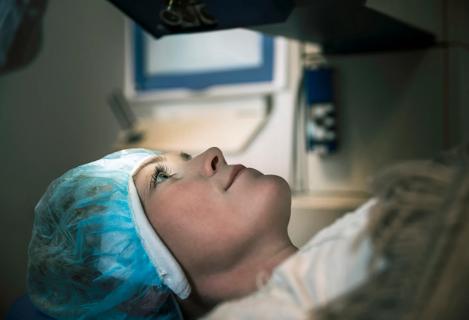 Patient lying on medical table awaiting an eye procedure