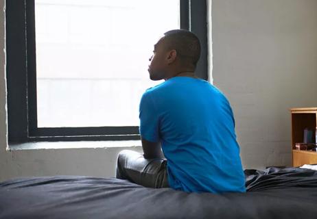 man sits alone on bed finding peace