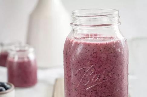 Berry vanilla smoothie in a mason jar ready for drinking.