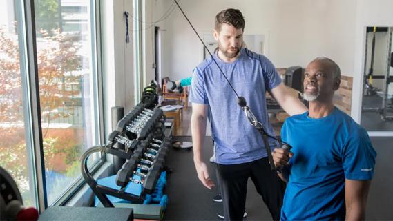 man exercising in rehab gym