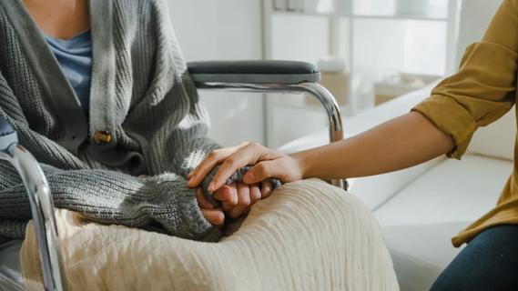 Depressed woman comforted by caregiver