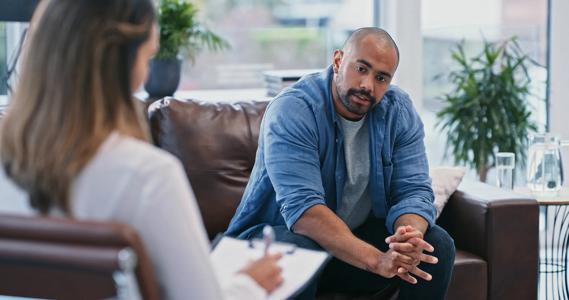 Person sitting on couch talking to therapist