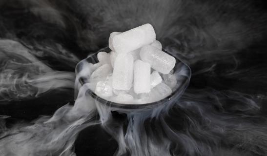 Dry ice in a bowl, with carbon dioxide gas being released