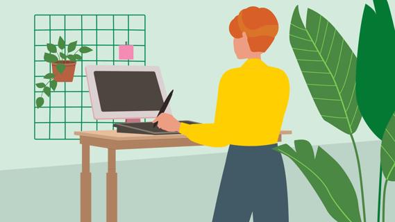 Person working on computer at a standing desk