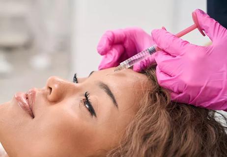 Person receiving botox injection from healthcare provider.