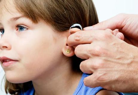 Child receiving hearing aid