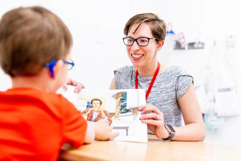 Dr. Cuffman reading book with young patient