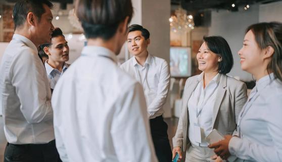 Asian employees meeting together