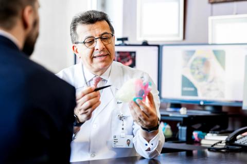 Dr. Najm with colorful 3D-printed heart model