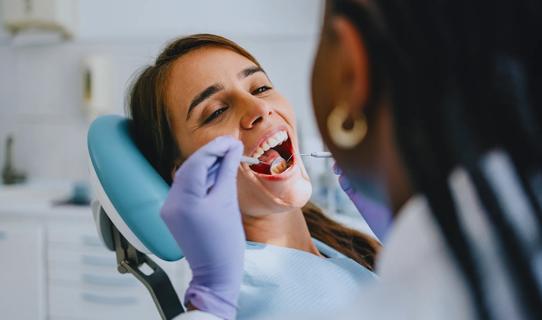 Patient receiving a dental exam for a cleaning