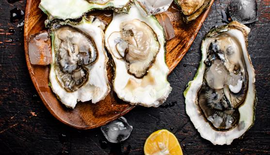 Oysters on a wooden serving tray