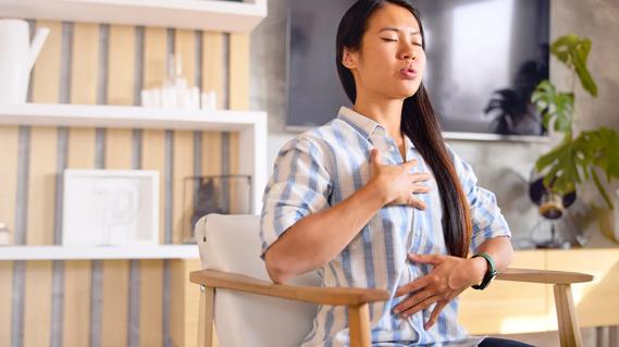 Person sitting, doing diaphragmic breathing