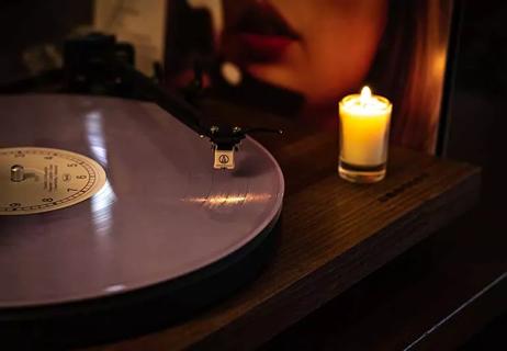 Taylor Swift's Midnights vinyl next to a candle.