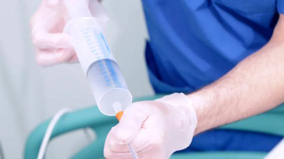 health worker preparing infusion of injectable drug